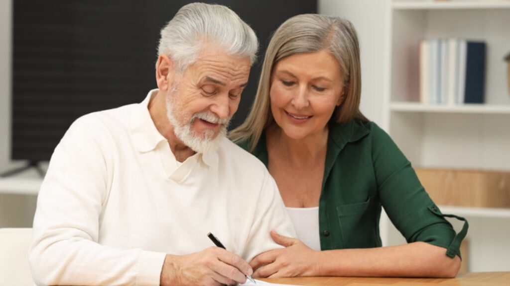 An older couple signing documents prepared by a Camarillo estate planning law firm