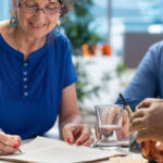 An older couple signing the plan their Camarillo estate planning attorney prepared