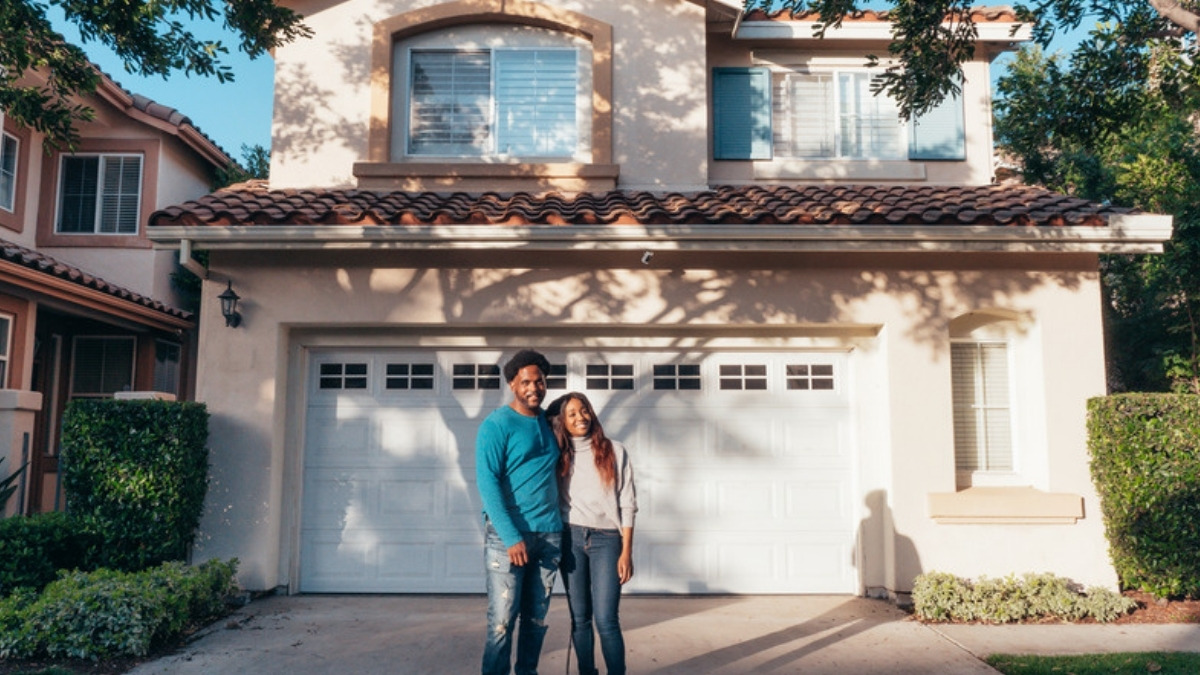 A couple outside the home their Camarillo living trust attorney will transfer into the trust