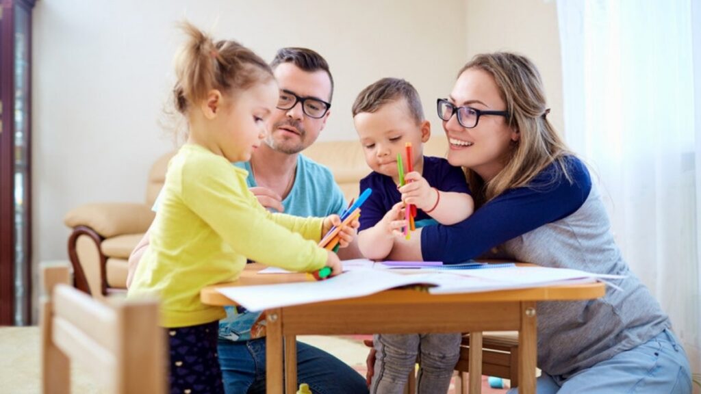 Parents drawing with their two young children, a family estate planning and trust attorneys in Los Angeles County help name a guardian