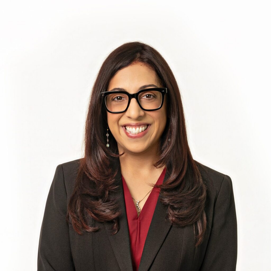 Portrait of estate planning attorney Marissa Garcia in a dark blazer and red blouse against a white backdrop