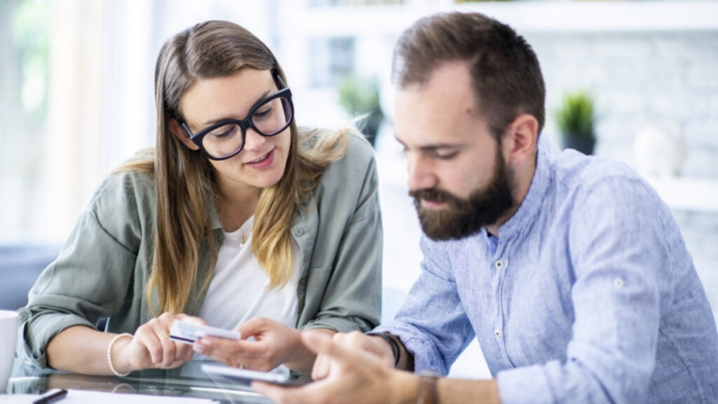 A young couple reviewing documents with an estate planning lawyer in Moorpark