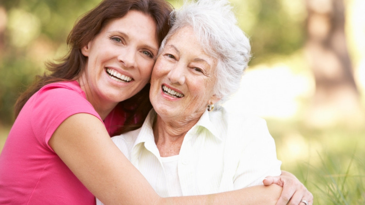 An adult daughter with her elderly mother, the families an estate planning lawyer in Northridge helps