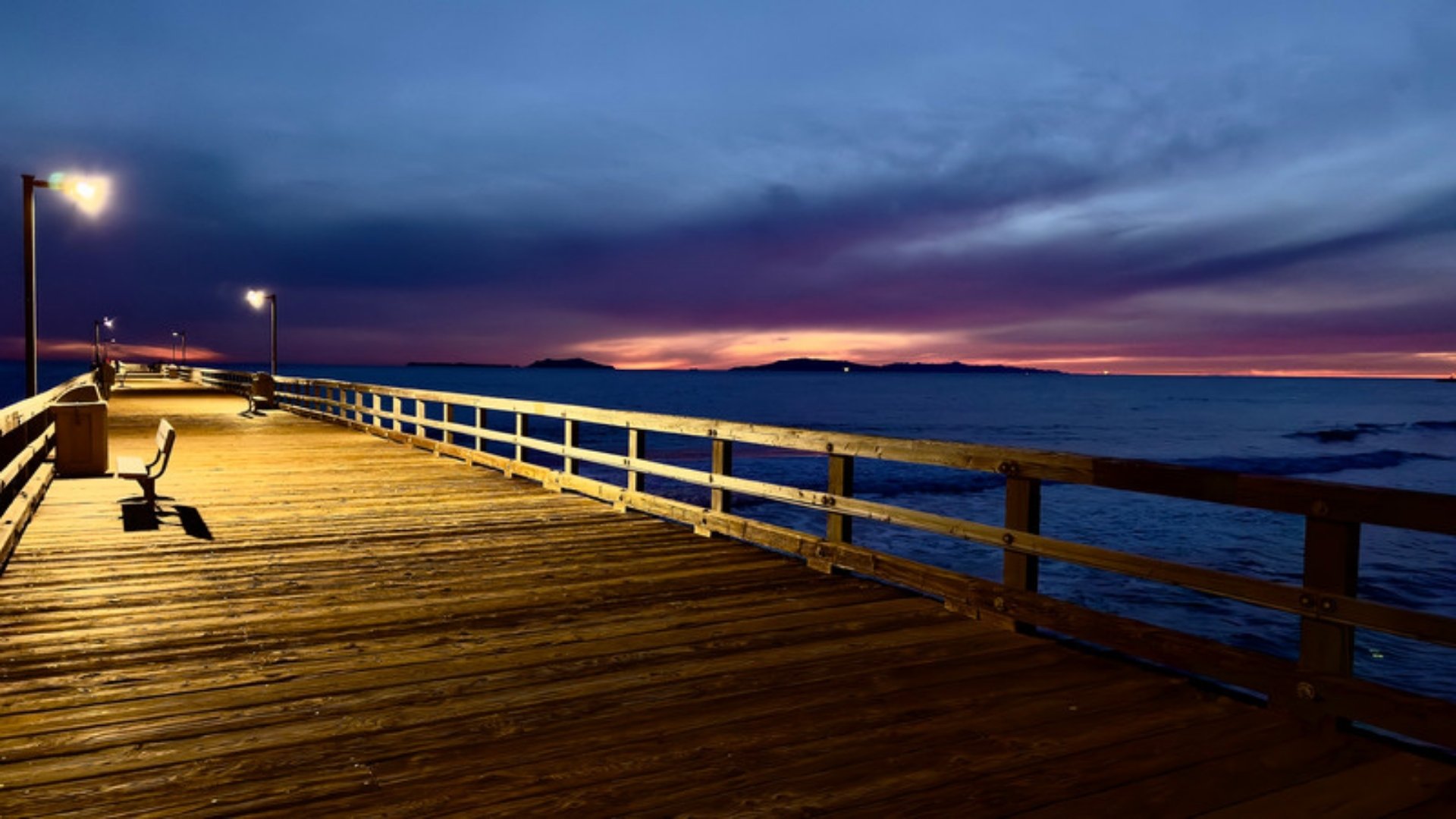 The Port Hueneme pier lit at dusk with the Channel Islands on the horizon, a landmark for families who meet an estate planning lawyer in Port Hueneme