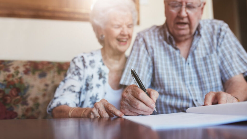 An older couple signing the documents their lawyer for powers of attorney in Camarillo prepared