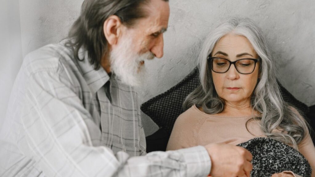 A husband tending to his wife at home, a situation that brings families to estate planning and trust attorneys in Ventura County